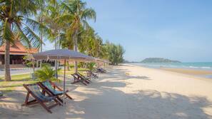On the beach, sun-loungers, beach umbrellas, beach towels