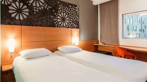 Premium bedding, desk, laptop workspace, blackout drapes