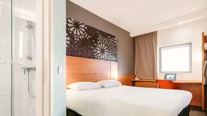 Premium bedding, desk, laptop workspace, blackout drapes