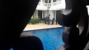 Outdoor pool, open 7 AM to 10 PM, pool umbrellas, pool loungers