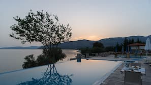 Indoor pool, seasonal outdoor pool, open 9 AM to 9 PM, pool umbrellas