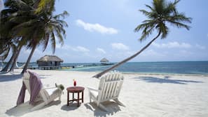 On the beach, white sand, sun-loungers, beach umbrellas