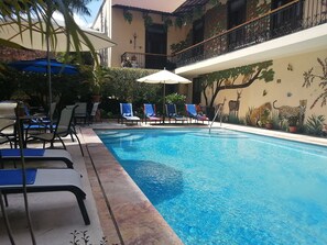 Outdoor pool, open 9:00 AM to 9:00 PM, pool umbrellas, sun loungers