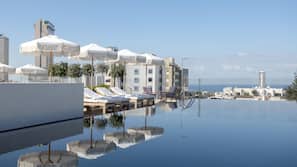 Seasonal outdoor pool, pool umbrellas, pool loungers