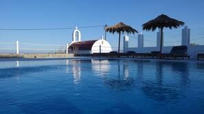 Seasonal outdoor pool, open 9 AM to 9 PM, pool umbrellas, pool loungers
