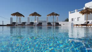 Seasonal outdoor pool, open 9 AM to 9 PM, pool umbrellas, pool loungers