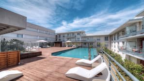 Seasonal outdoor pool, open 10:00 AM to 9:00 PM, pool umbrellas