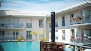 Seasonal outdoor pool, open 10:00 AM to 9:00 PM, pool umbrellas