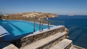 Outdoor pool, an infinity pool, pool loungers