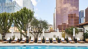 Outdoor pool, open 7 AM to 7 PM, pool umbrellas