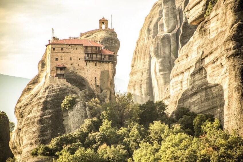 A monastery perched atop a rock formation. 4