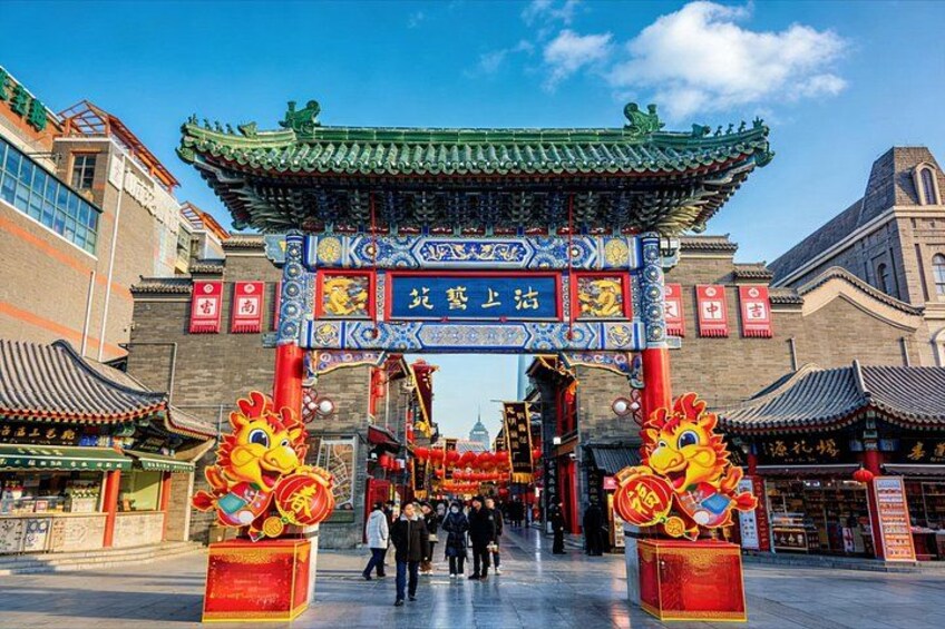 A traditional Chinese gate with ornate decorations and lion statues. 2