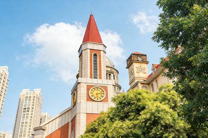 A church with a red spire and a clock tower. 5