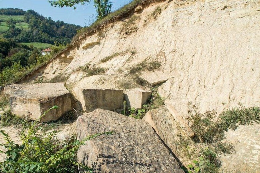 A rocky hillside with large boulders and a steep drop. 2