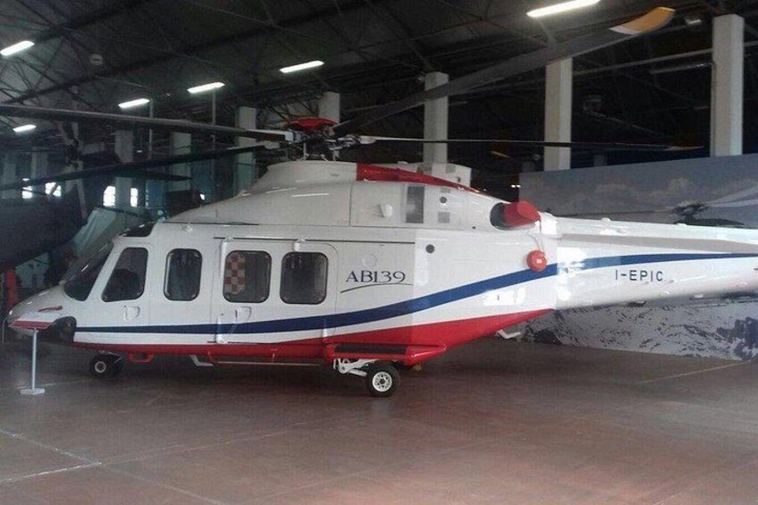 A helicopter with the registration number AB139, labeled 'I-EPIC,' parked indoors. 2