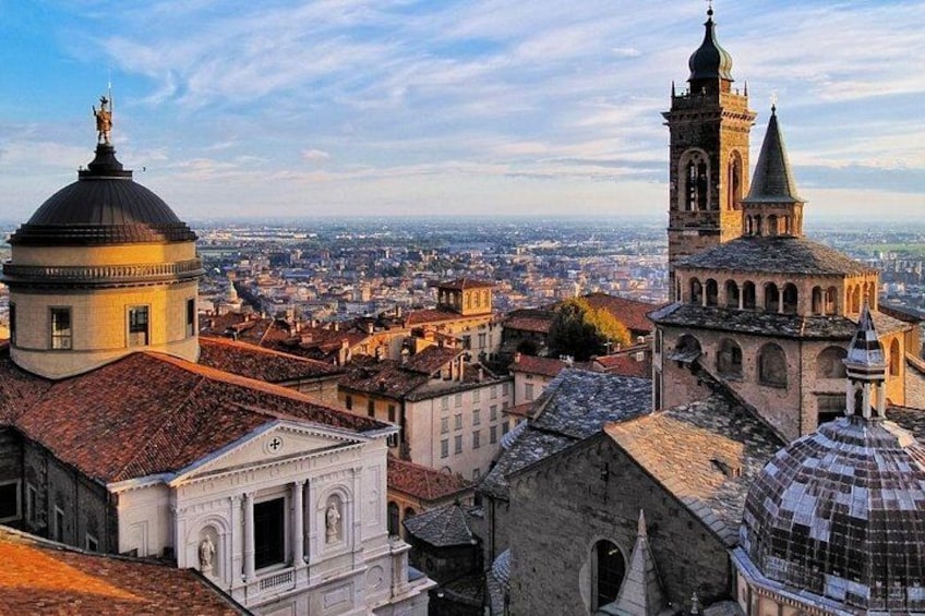 A cityscape with prominent historical architecture, including domed buildings and a tower with a spire. 2