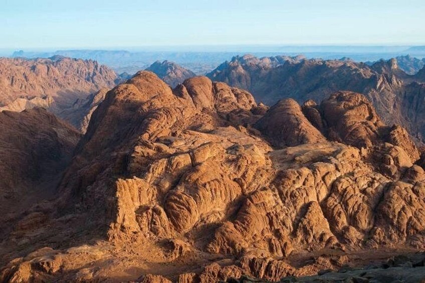A rugged mountainous landscape with prominent rocky formations and a vast horizon. 3