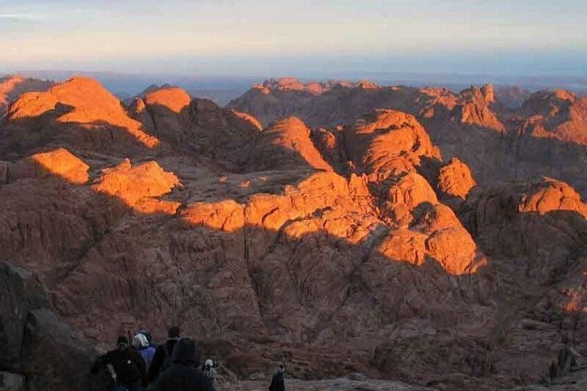 A rugged mountain landscape with rocky formations and a clear sky. 4