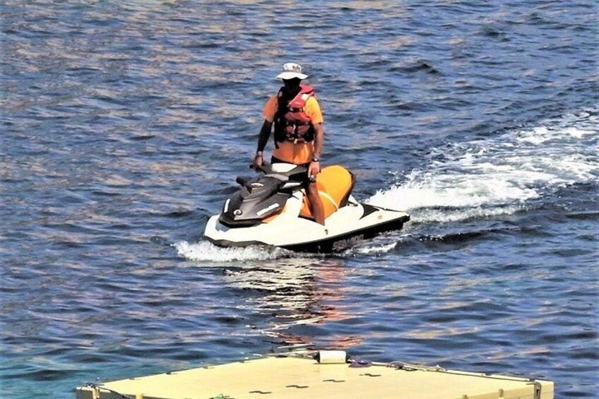 A person riding a jet ski on water. 3