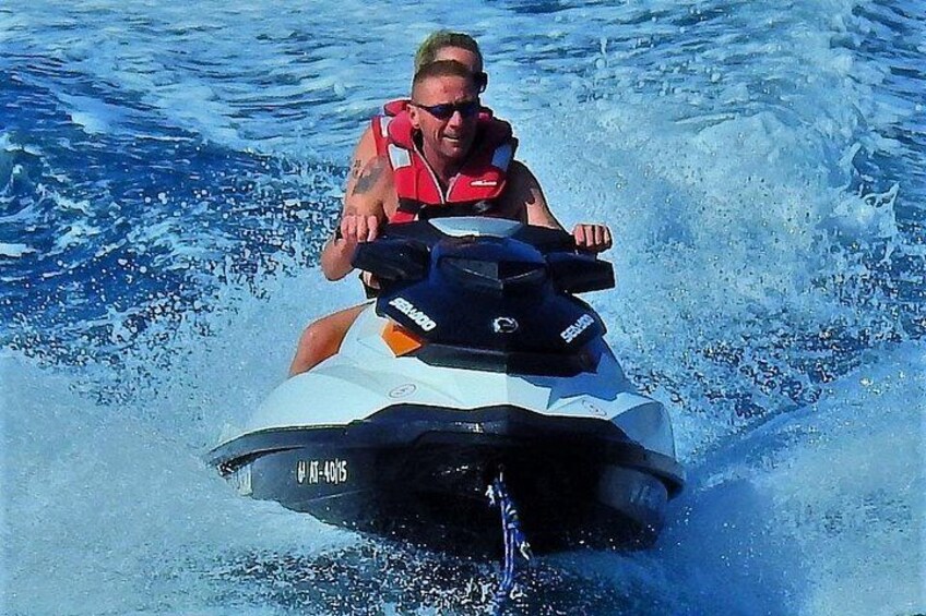 A person riding a jet ski on water. 5