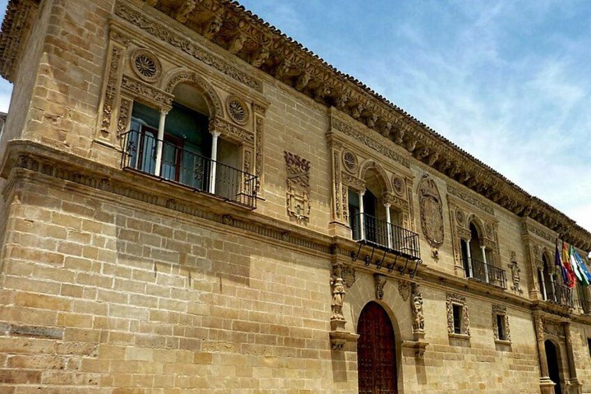 A historic building with ornate architectural details, including arched windows and decorative stonework. 1