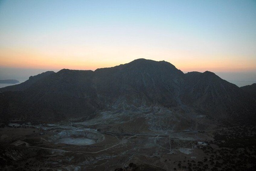 A mountainous landscape during sunset with a clear sky. 3