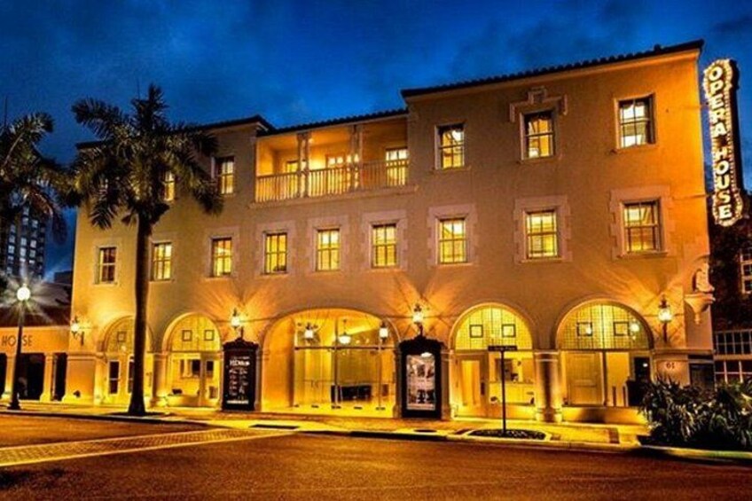 A multi-story building with illuminated windows and a sign that reads 'OPERA HOUSE.' 5