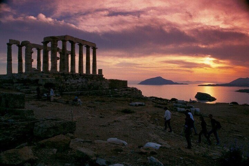 Ancient ruins at sunset with a calm sea and distant mountains. 4
