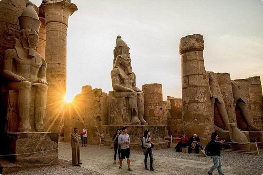 Ancient Egyptian statues and columns at sunset. 5