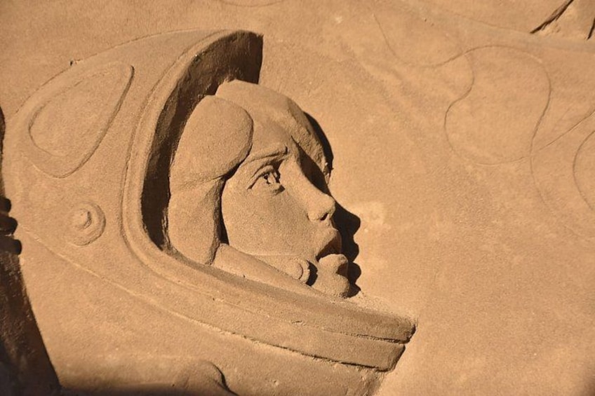 A detailed sand sculpture of a person's profile with a headdress. 2
