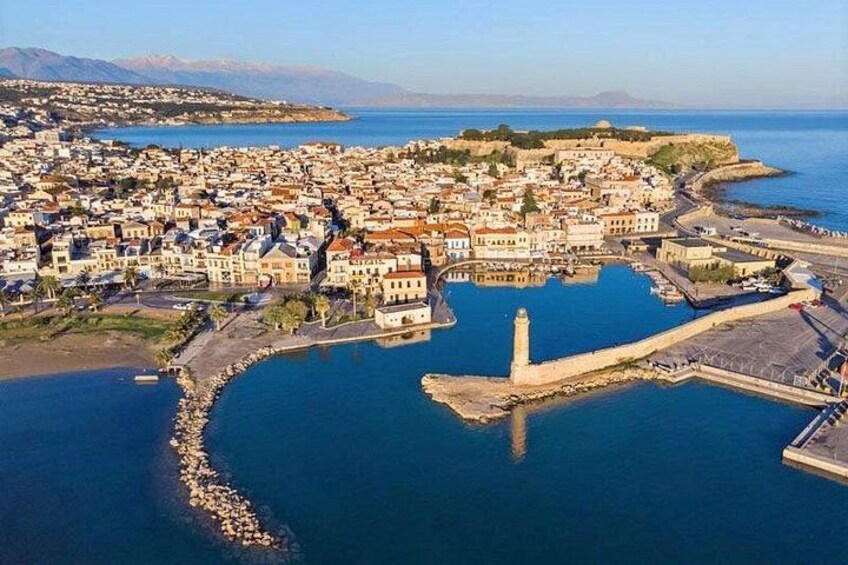 A coastal town with a prominent lighthouse, a harbor, and a fortified area. 5