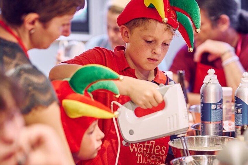 A person wearing a festive hat pouring from a white container into a metal bowl. 4