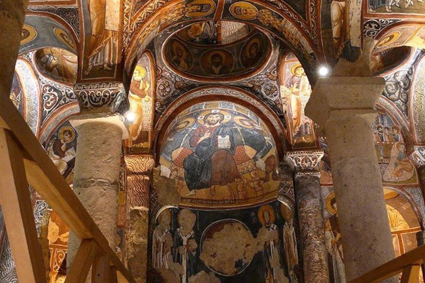 A detailed mosaic with religious figures, ornate columns, and a domed ceiling. 1