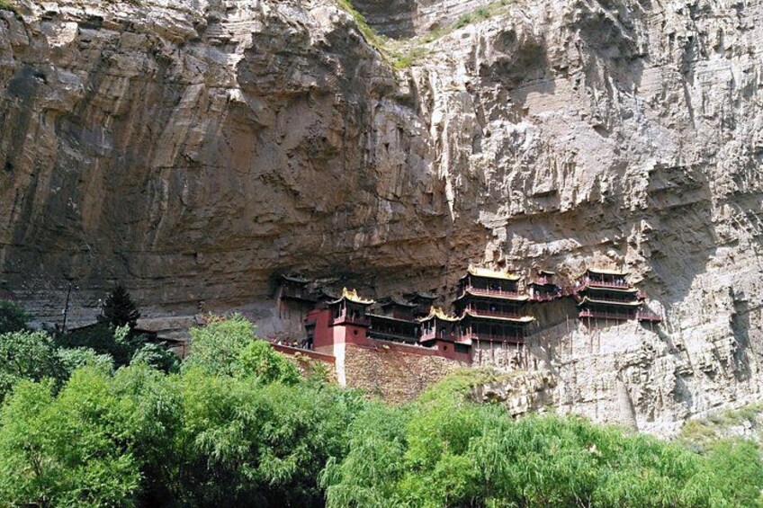 A cliffside with traditional multi-tiered buildings. 3