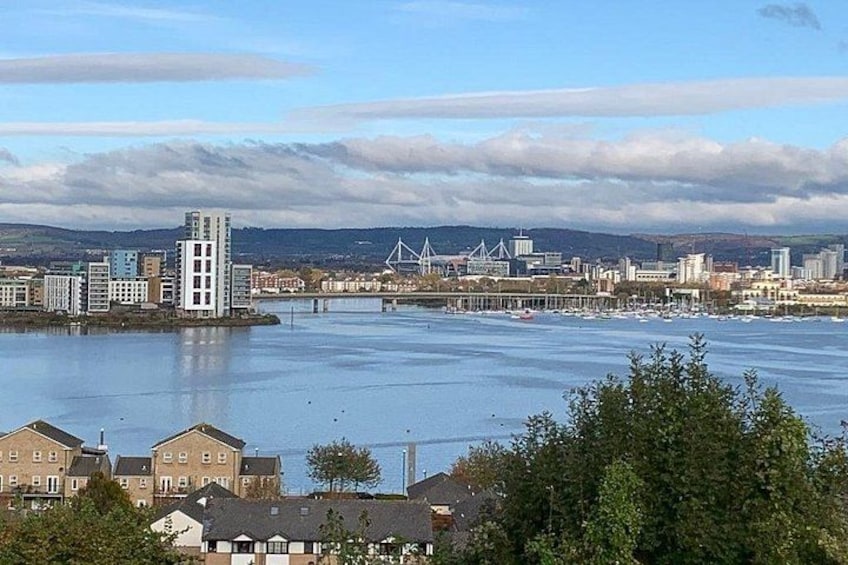 A river with buildings and a bridge in the background. 3