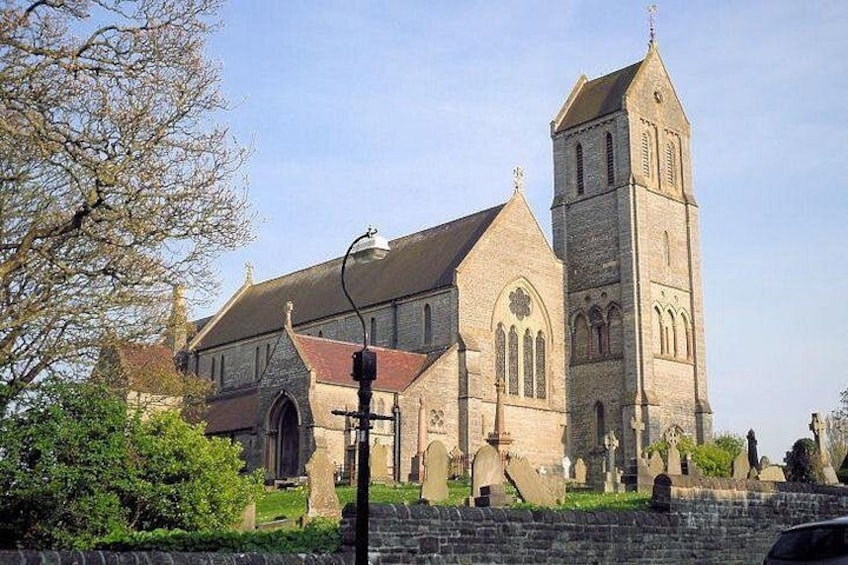 A church with a tall tower and a stone facade. 4