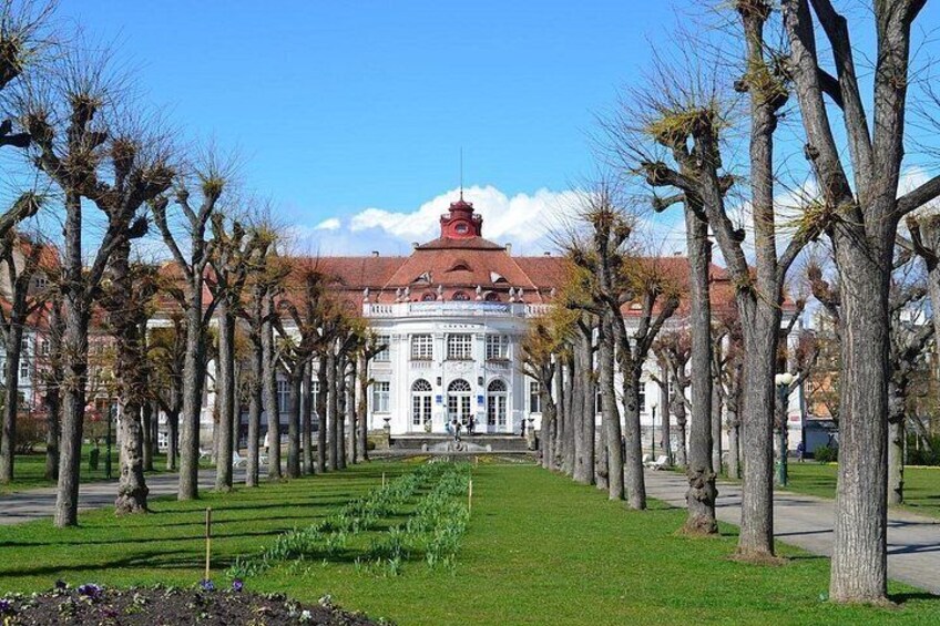 A building with a red roof, surrounded by a row of trees. 5