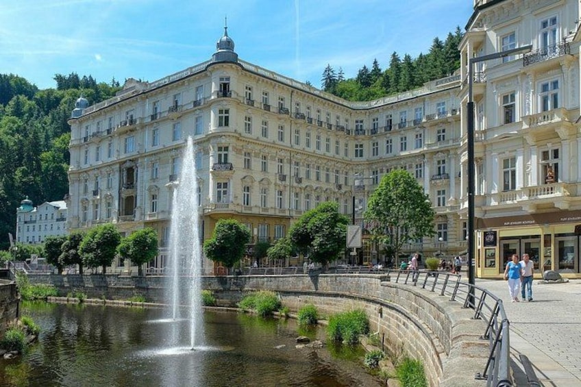 A historic building with a fountain in front. 1