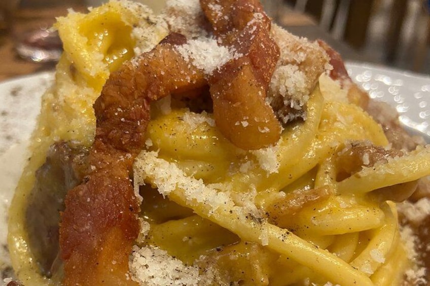 A plate of spaghetti with meat and grated cheese. 5