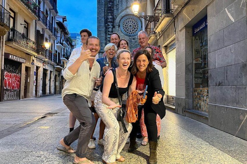 A group of people walking on a city street at dusk. 2