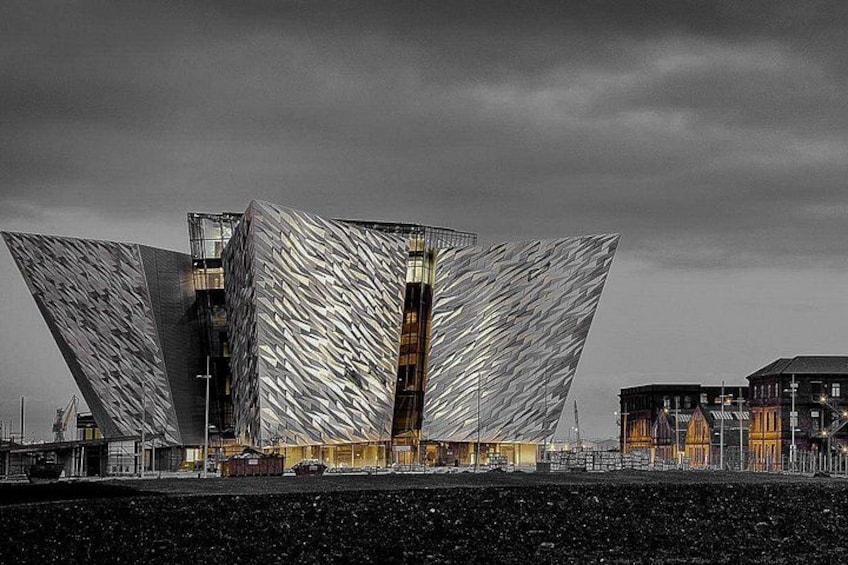 A modern architectural building with a unique angular design, located near a waterfront. 1