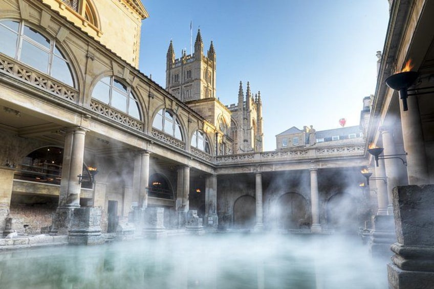 A historic building with arched bridges and a central fountain. 1