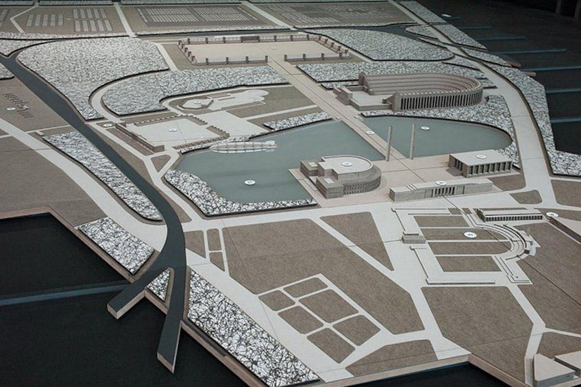 A detailed model of a city layout with roads, buildings, and a central circular plaza. 4