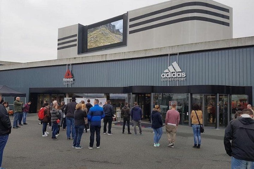A modern building with an Adidas outlet and a Reebok outlet. 4