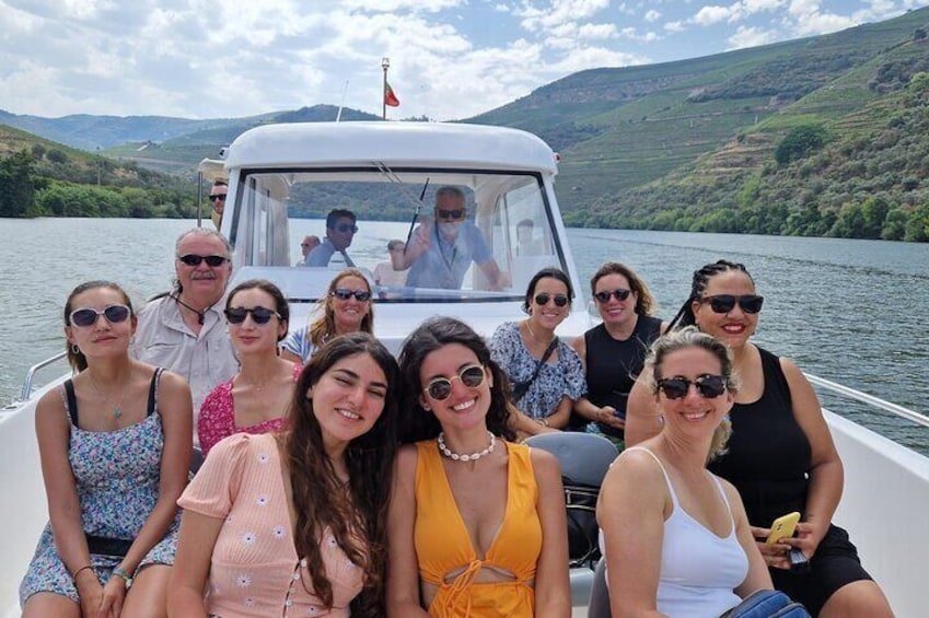 A group of people on a boat on a lake with hills in the background. 4