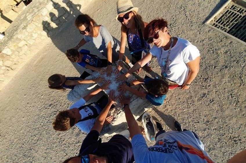 A group of people gathered in a circle, possibly for a team-building activity. 3
