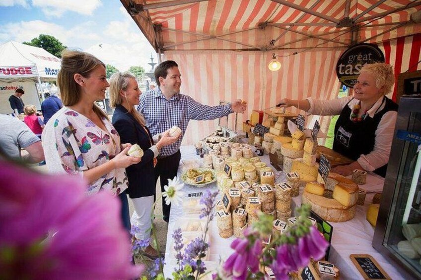 A cheese tasting event with a variety of cheeses displayed on a table. 3