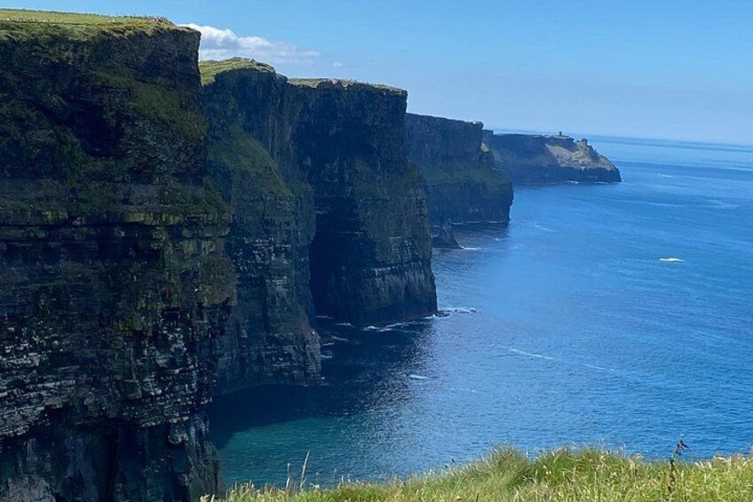 A coastal cliff with a clear view of the ocean. 2