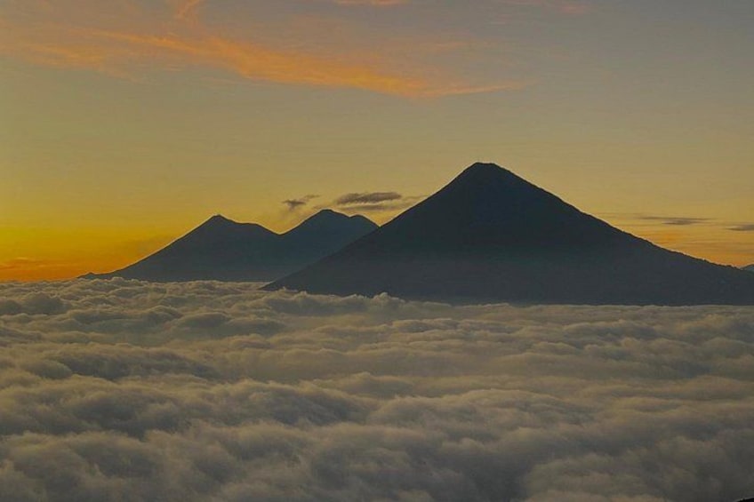 A mountain range with clouds below. 1