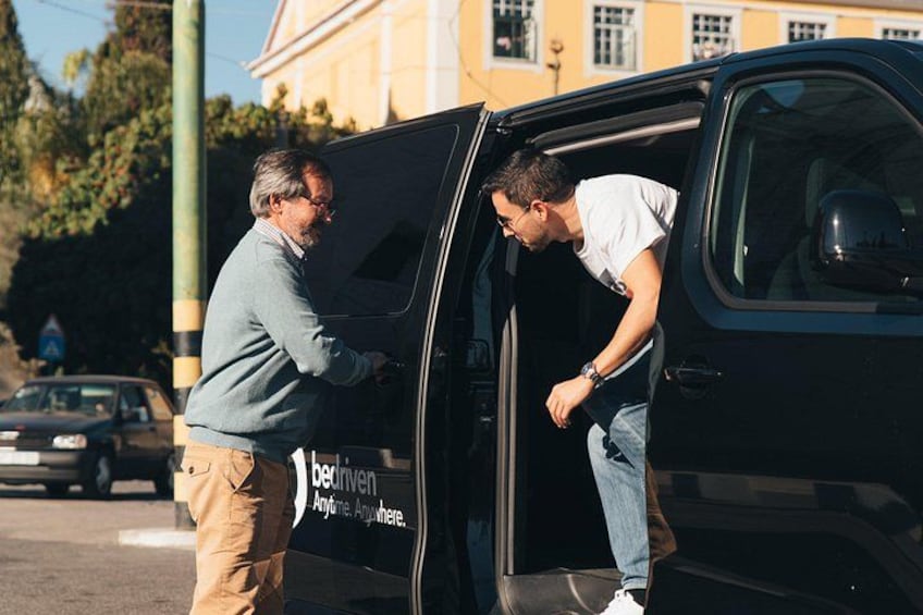 A man getting into a van with a logo that reads 'dediven Anywhere.' 5